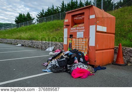 Prestatyn, Wales Uk: Jun 7, 2020: A Charity Clothing Bank Is Overflowing. Excess Donations In Plasti