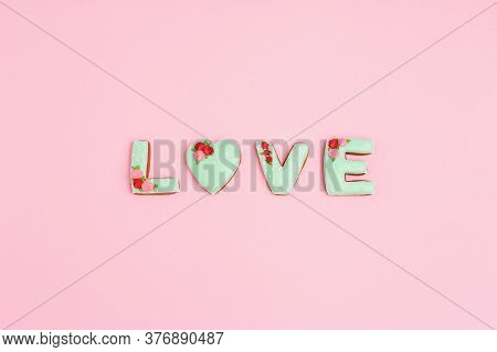 Gingerbread Heart, Cookies In Shape Of Letter Love With Icing On Pastel Pink Background. Valentines 