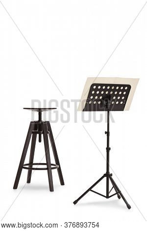 Studio shot of a black chair and a music notebook on a stand isolated on white background