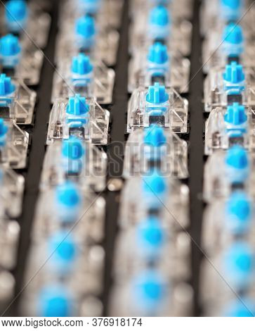Caucasian technician repairing a mechanical keyboard with blue switches
