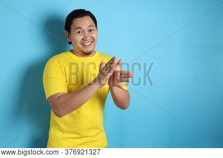 Young Asian Man Wearing White Shirt, Happy Proud Clapping Gesture.over Grey Background, Halfl Body P