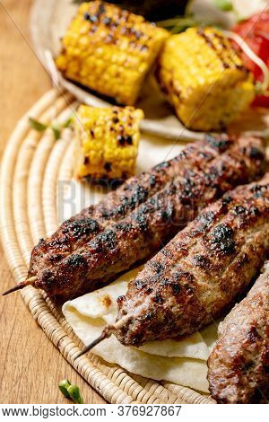 Eastern Fast Food. Grilled Beef Lyulya Kebab On Sticks On Flat Bread With Grilled Vegetables Sweet C