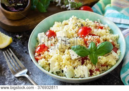 Oriental Cuisine. Healthy Salad With Couscous, Tomatoes, Feta Cheese, Basil, Chili Pepper And Olive