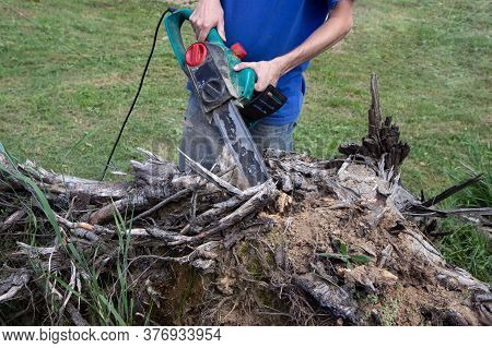 Electric Saw In Action Cutting Wood. Man Cutting Wood With Saw, Dust And Movements. Close-up Of Wood