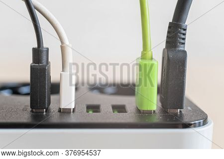 Modern Convenient Multi-port Usb Charger For Devices. Close-up Of Multi-colored Cables In A Power Ou