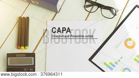 Paper With Corrective And Preventive Capa Action Plans On A Table