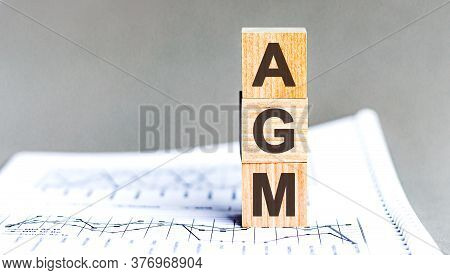 Agm Annual General Meeting Acronym On Wooden Cubes On Grey Backround. Business Concept.