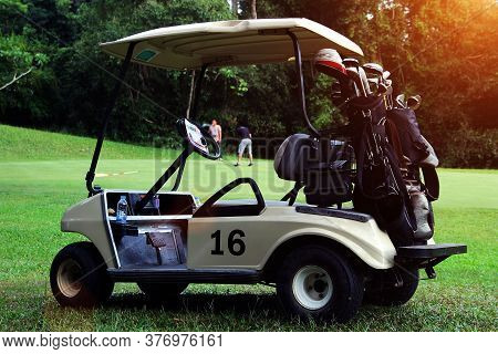 Golfcar In Beautiful Golf Course In The Evening Golf Course With Sunshine In Thailand