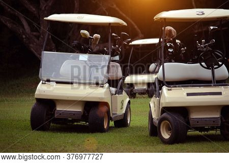 Golfcar In Beautiful Golf Course In The Evening Golf Course With Sunshine In Thailand