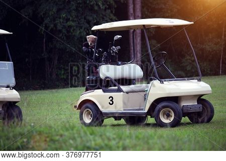 Golfcar In Beautiful Golf Course In The Evening Golf Course With Sunshine In Thailand