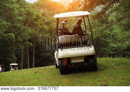 Golfcar In Beautiful Golf Course In The Evening Golf Course With Sunshine In Thailand