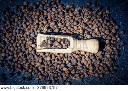 Peppercorns Of Piper Cubeba With A Wooden Spoon