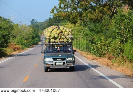 Pran Buri, Thailand - December 13, 2013: Agricultural Workers In Isuzu Pickup Truck Ride With A Larg