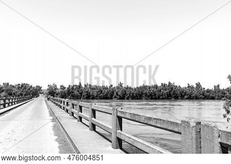 The Road Bridge Over A Flooded Orange River At Grootdrink In The Northern Cape Province. Monochrome