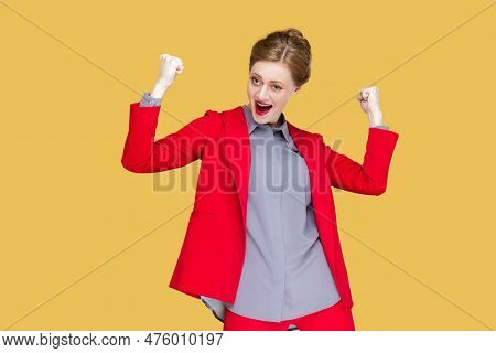 Portrait Of Extremely Happy Woman With Red Lips Standing Raised Her Clenched Fists, Screaming Hurray