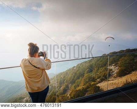 Woman Enjoys The View From The Viewpont Over Oludeniz, Turkey. Sunset, Clouds, Paragliders. Mount Ba
