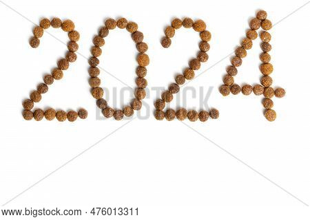 Calendar 2024 From Dry Pet Food On A White Background. Granules Of Good Nutrition For Dogs And Cats.