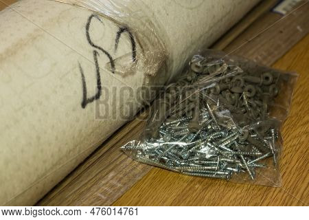 Packaging Made Of Film With Self-tapping Screws Lies On The Floor
