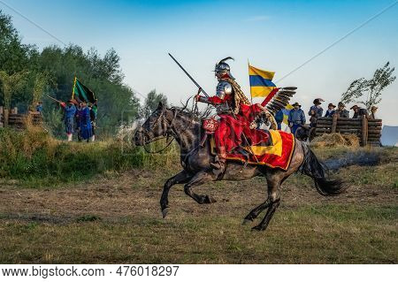 Gniew, Poland, Aug 2020 Polish Winged Hussar, Heavy Cavalry, In Full Gallop With Swords Out. Histori