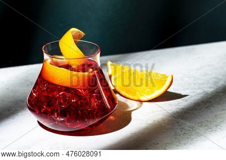 Boulevardier Alcoholic Cocktail Drink With Bourbon, Vermouth, Bitter, Orange Zest And Ice. Dark Gree