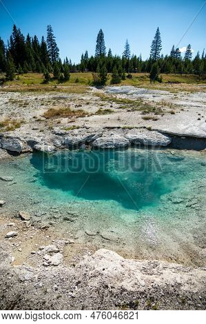 Light Blue Pool Steams Near The Boardwalk Of West Thumb In Yellowstone