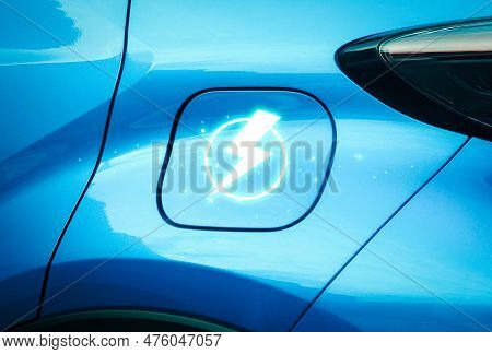 Close Up Of A Blue Ev Electric Vehicle With Lightning Charger Symbol On The Lid Of Battery Charger S