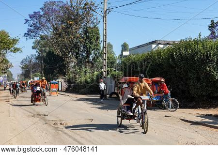 Antsirabe, Madagascar - November 1. 2022: Traditional Rickshaw Bicycle With Malagasy People On The S