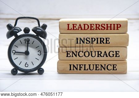 Leadership, Inspire, Encourage, Influence Text On Wooden Blocks With White Cover Background.