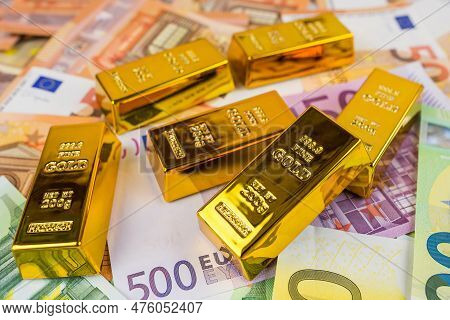 Euro Banknotes And Gold Bars. Gold Bars On Money