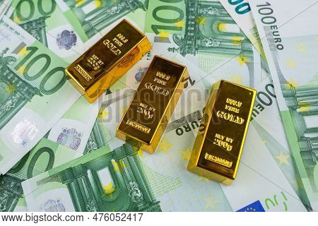 Euro Banknotes And Gold Bars. Gold Bars On Money