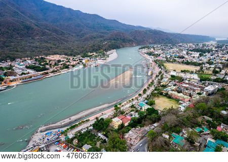 Aerial Drone Shot Over Ram Setu Jhula Suspension Bridge With Temples On The Bank Of River Ganga In T