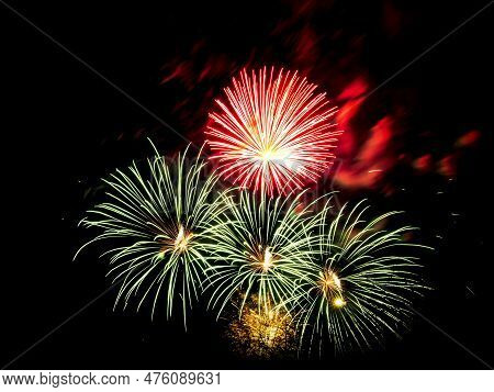 Multiple Fireworks Against The Deep Black Sky. Bright  Display Of The Fireworks