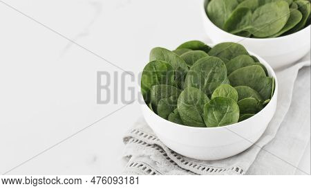 Fresh Baby Raw Spinach On A Plate. Copy Space. Healthy Eating.