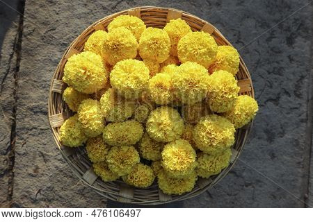 Fresh Marigold Flowers Bunch In Wicker Basket On Floor