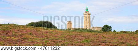 Lighthouse And Flowers At Cap Frehel, Brittany. Travel Destination At The French Coast.