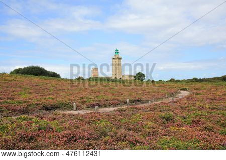 Lighthouse And Flowers At Cap Frehel, Brittany. Hiking Trail At The French Coast.