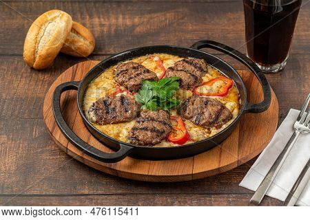 Meatballs With Alinazik Sauce. Traditional Turkish Meatballs On Eggplant Puree In Cast Iron Skillet