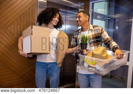 Young Couple With The Clothes In Hands In The Hotel