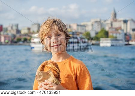 Boy In Istanbul Having Breakfast With Simit And A Glass Of Turkish Tea. Glass Of Turkish Tea And Bag