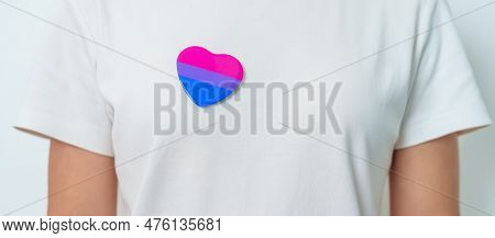 Bisexuality Celebrate Day And Lgbt Pride Month,  Lgbtq+ Or Lgbtqia+ Concept. Hand Holding Purple, Pi