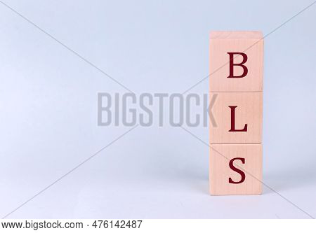 Bls On A Wooden Cubes On A Blue Background