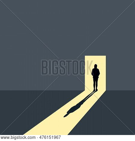Lonely Girl Stands In Front Of An Open Door On A Gray Wall