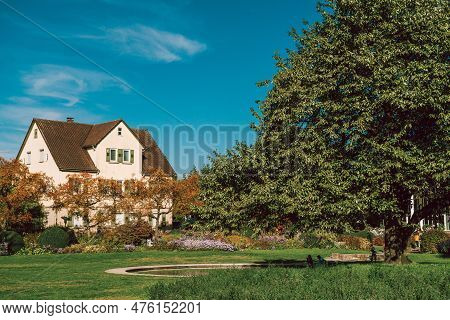 House With Nice Garden In Fall. Flowers In The City Park Of Bietigheim-bissingen, Baden-wuerttemberg
