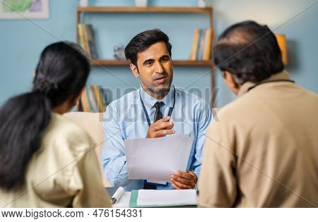 Shoulder Shot, Indian Banker Explaining About Future Investment Plans Or Pension Scheme Offer To Sen