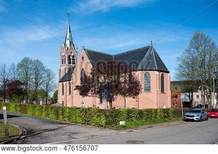 Zammel, Flanders, Belgium - April 22, 2023 - The Catholic Church Of Zammel Against A Blue Sky