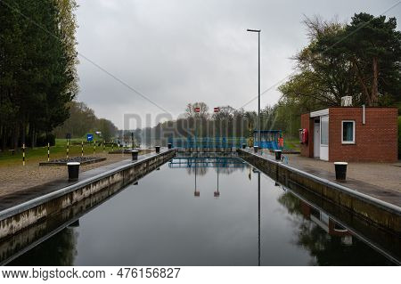 Geel, Flanders, Belgium - April 22, 2023 - Industrial Reflections At The Sluice