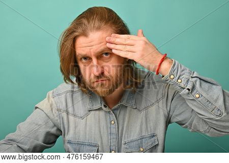 Man In Front Of Mirrror Looking At His Wrinkles