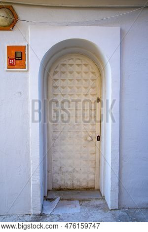 A White Narrow Door In A Turkish House With An Arch And A Window. Concept Architecture And Landmarks