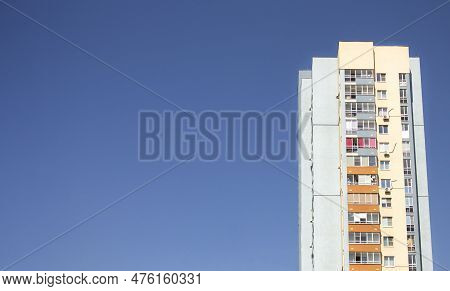 Multi-storey Residential Building Against The Background Of Clear Blue Sky.