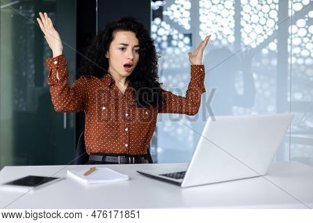 Annoyed And Angry Businesswoman Inside Office At Workplace, Hispanic Woman Disappointed Received Onl